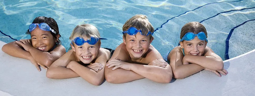 kids smiling while swimming