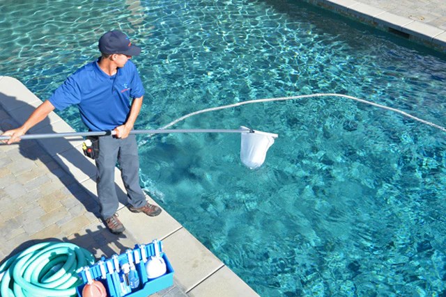 Person cleaning a pool image
